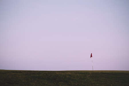 Flag on the green at golf course Vintage Retro Filter.の写真素材