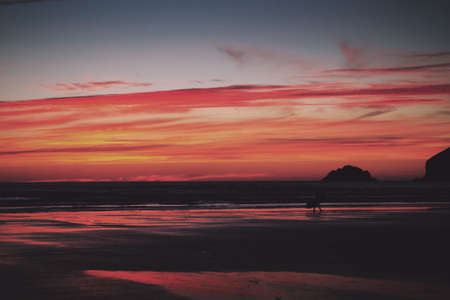 Colourful sunset over the beach at Polzeath, Cornwall. Vintage Retro Filter.の写真素材