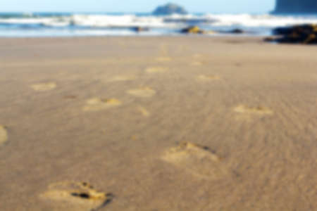 Footprints in the sand on Polzeath beach, Cornwall Out of focus.の写真素材