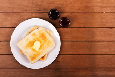 Slices of warm toast against a rustic wooden background