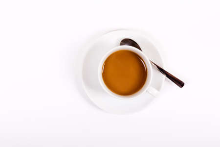 Coffee in white cup and saucer on a white background