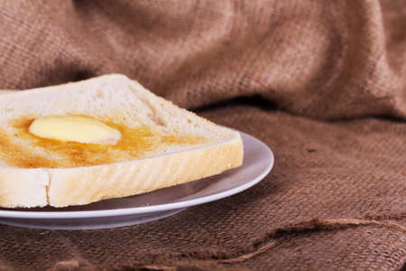 Slices of warm toast against a rustic wooden backgroundの写真素材