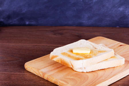 Slices of warm toast against a rustic wooden backgroundの写真素材