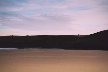 Early morning view of the beach at Polzeath, Cornwall Vintage Retro Filter.