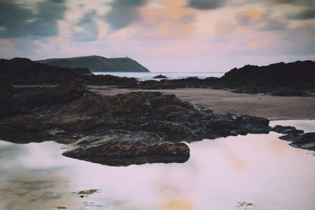 Early morning view over the beach at Polzeath, Cornwall Vintage Retro Filter.の写真素材