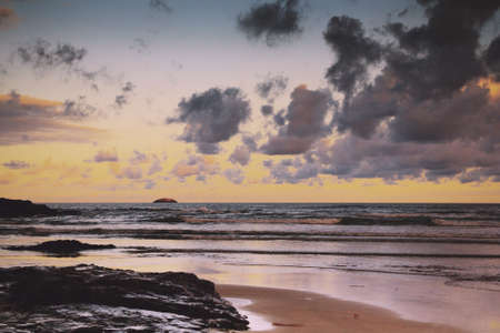 Early morning view of the beach at Polzeath, England Vintage Retro Filter.の写真素材