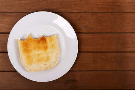 Slices of warm toast against a rustic wooden background