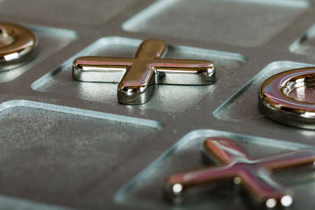 Close up of a metal tic tac toe board