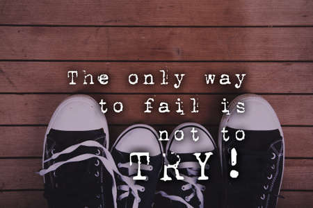 Old worn canvas shoes on a wooden floor Vintage Retro Filter.の写真素材