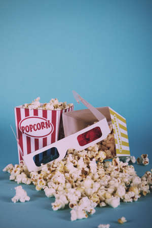 Bucket of popcorn against a blue background Vintage Retro Filter.の写真素材