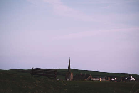 View of a church in Bude from the golf course Vintage Retro Filter.の写真素材