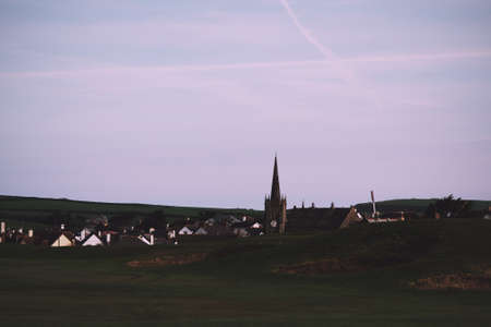 View of a church in Bude from the golf course Vintage Retro Filter.の写真素材