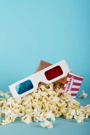 Bucket of popcorn against a blue backgroundの写真素材