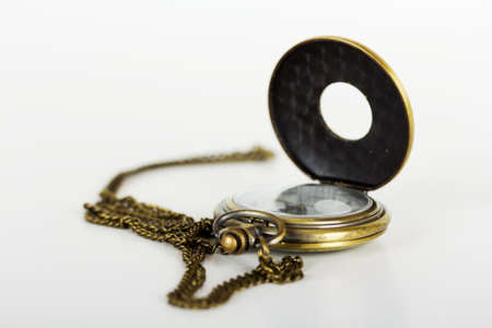 Pocket watch against a light coloured backgroundの写真素材