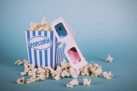 Bucket of popcorn against a blue background Vintage Retro Filter.の写真素材