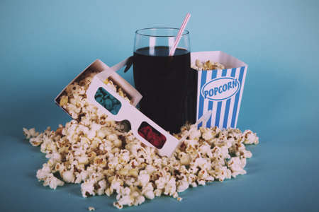 Bucket of popcorn against a blue background Vintage Retro Filter.の写真素材