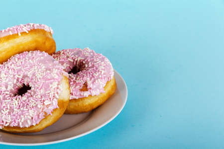 Iced doughnut on a light coloured blue backgroundの写真素材