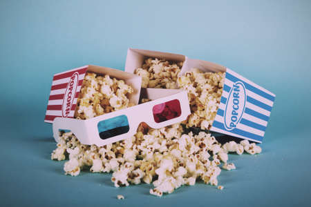 Bucket of popcorn against a blue background Vintage Retro Filter.