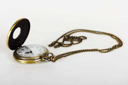 Pocket watch against a light coloured background