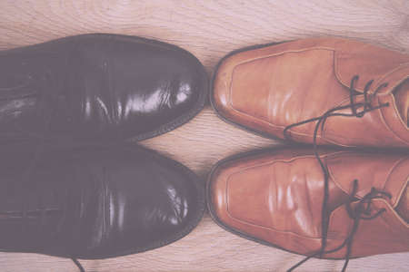 Shoes on a rustic wooden floor Vintage Retro Filter.