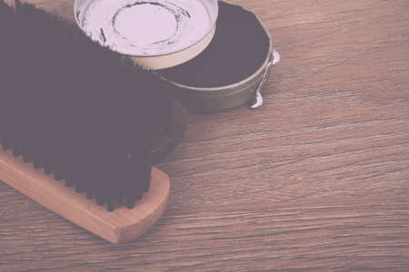 Shoe polishig equipment on a rustic wooden floor Vintage Retro Filter.の写真素材
