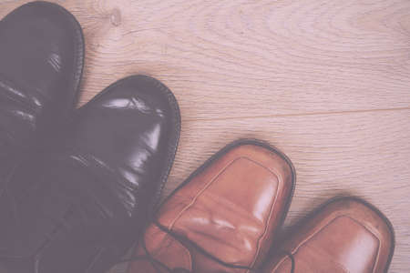 Shoes on a rustic wooden floor Vintage Retro Filter.