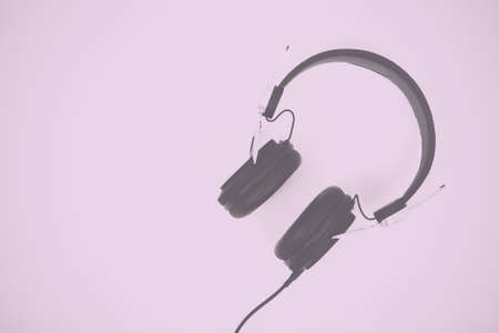 Pair of headphones against a light coloured background Vintage Retro Filter.の写真素材