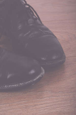 Shoes on a rustic wooden floor Vintage Retro Filter.