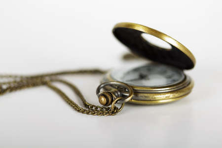 Pocket watch against a light coloured backgroundの写真素材