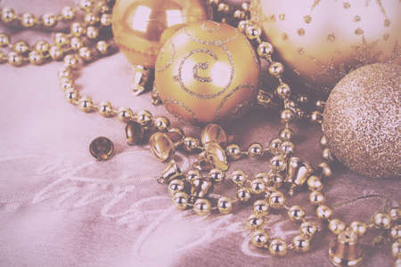 Festive gold Christmas decorations on a fabric background Vintage Retro Filter.の写真素材
