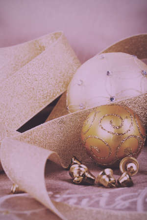 Festive gold Christmas decorations on a fabric background Vintage Retro Filter.の写真素材