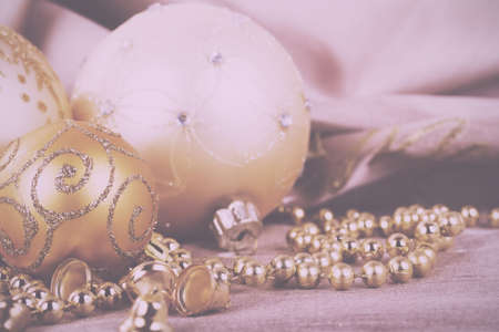 Festive gold Christmas decorations on a fabric background Vintage Retro Filter.の写真素材