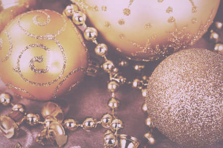 Festive gold Christmas decorations on a fabric background Vintage Retro Filter.の写真素材