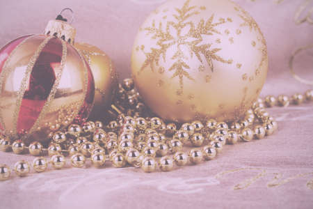Festive gold Christmas decorations on a fabric background Vintage Retro Filter.の写真素材