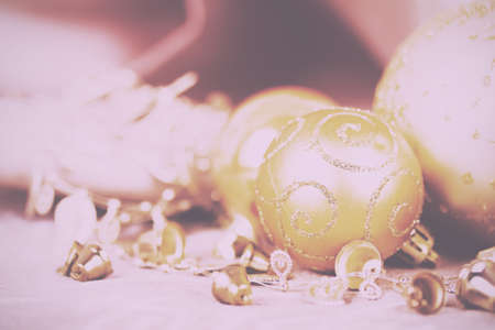 Festive gold Christmas decorations on a fabric background Vintage Retro Filter.の写真素材