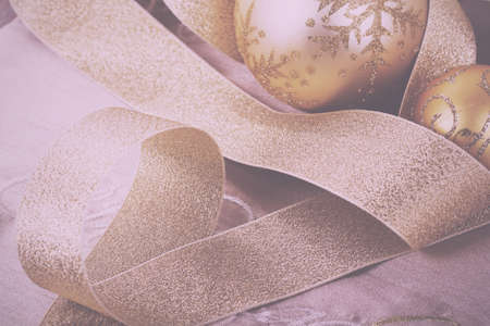 Festive gold Christmas decorations on a fabric background Vintage Retro Filter.の写真素材
