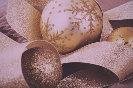 Festive gold Christmas decorations on a fabric background Vintage Retro Filter.の写真素材