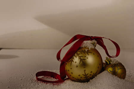 Gold Christmas decorations in white snow for a background HDR Filter.の写真素材