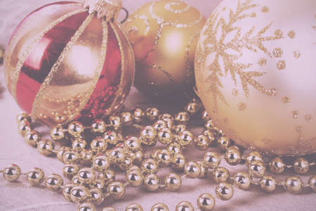 Festive gold Christmas decorations on a fabric background Vintage Retro Filter.