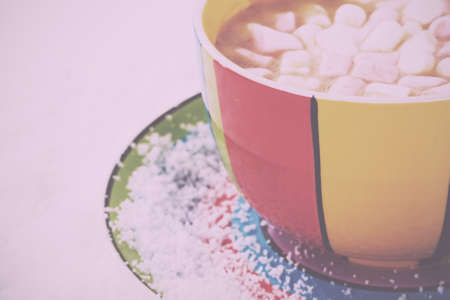 Hot chocolate in a bright and colourful cup Vintage Retro Filter.の写真素材