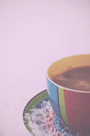 Hot chocolate in a bright and colourful cup Vintage Retro Filter.の写真素材