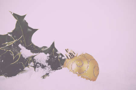 Chrismas decorations with holly on a white snow background Vintage Retro Filter.の写真素材