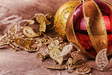 Festive gold Christmas decorations on a fabric background HDR Filter.の写真素材