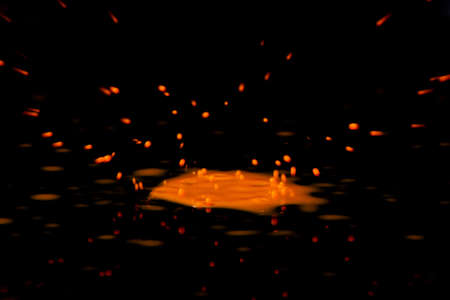 Colorful paint drop splashing on black a background