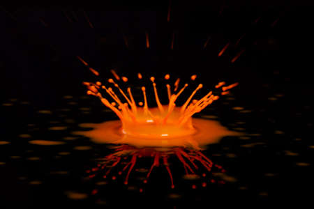 Colorful paint drop splashing on black a backgroundの写真素材