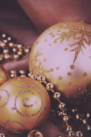 Festive gold Christmas decorations on a fabric background Vintage Retro Filter.の写真素材