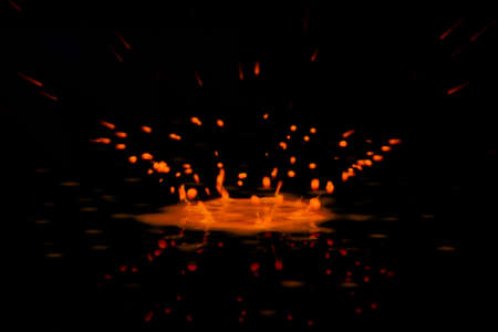 Colorful paint drop splashing on black a backgroundの写真素材