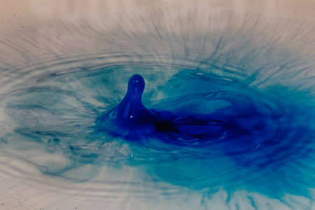 Colorful paint drop splashing on black a background HDR Filter.の写真素材