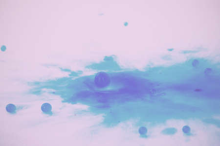 Colorful paint drop splashing on black a background Vintage Retro Filter.の写真素材