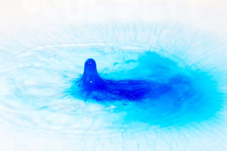 Colorful paint drop splashing on black a backgroundの写真素材